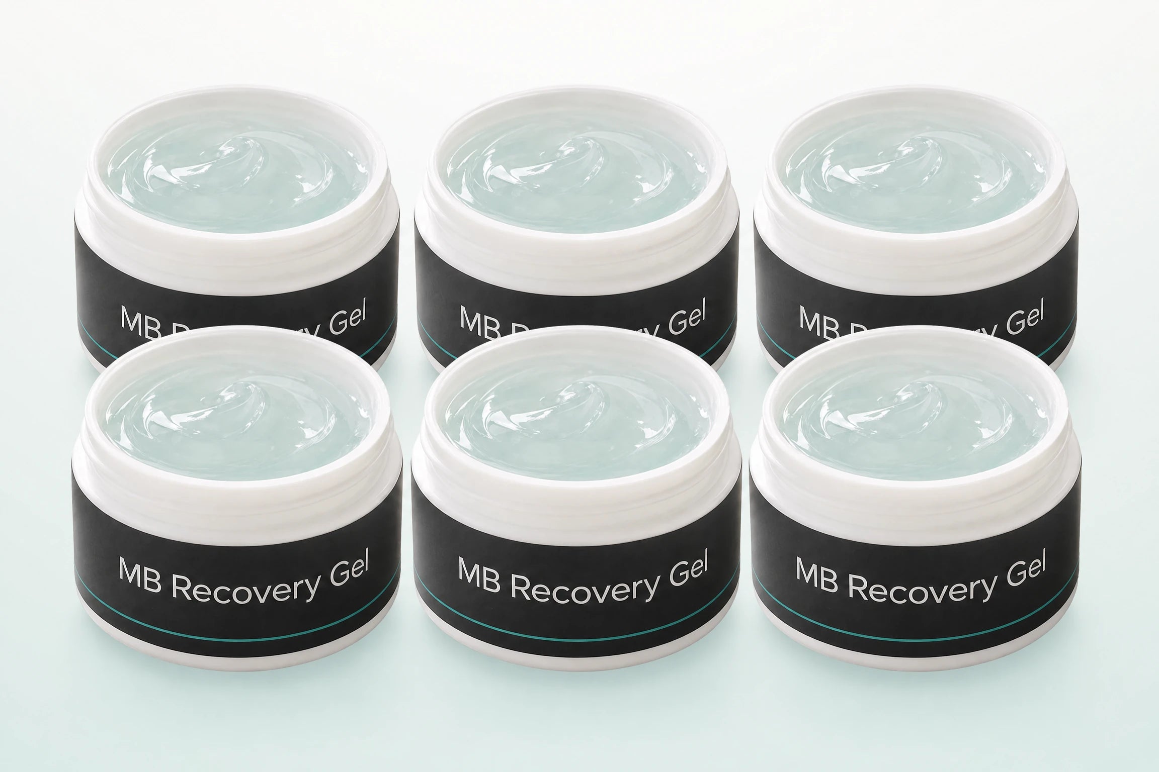 Six MB Recovery Gel jars arranged together in one clean product composition